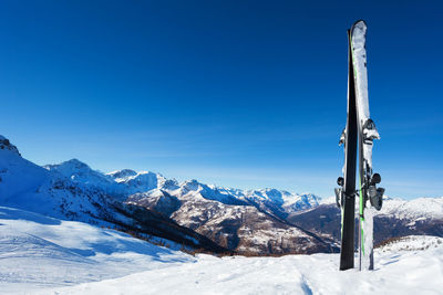 Scenic view of snowcapped mountains against clear blue sky