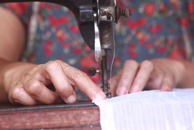 Cropped hands sewing machine