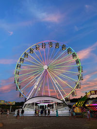 Ferris wheel in amusement park against sky