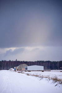 Snow covered field against sky