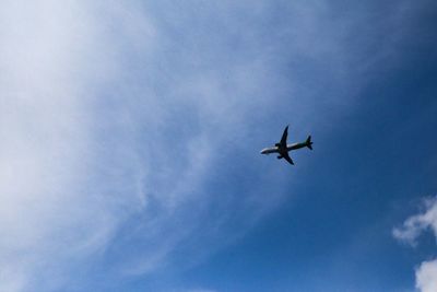 Low angle view of airplane flying in sky