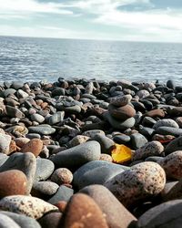 Pebbles on beach against sky