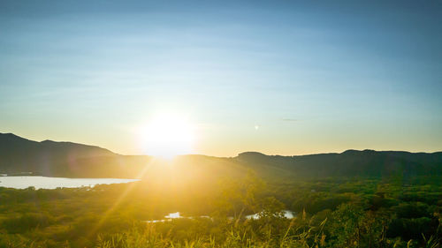 Scenic view of field against sky during sunset