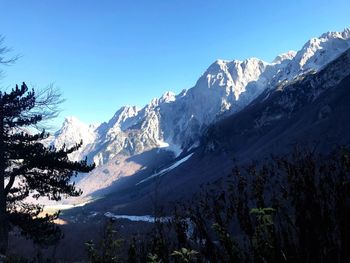 Scenic view of snowcapped mountains against clear blue sky