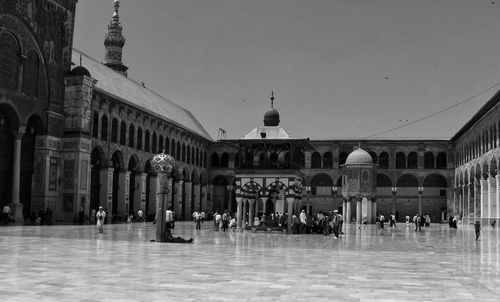 People at mosque against clear sky