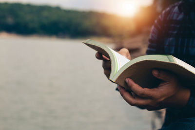 Close-up of hand holding book