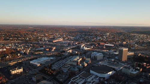 High angle view of illuminated buildings in city against clear sky