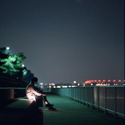 View of illuminated woman at night