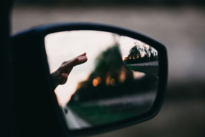 Close-up of hand on side-view mirror