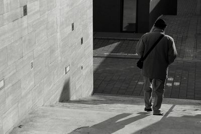 Full length rear view of man standing outdoors