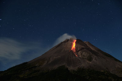 Scenic view of volcanic mountain against sky at night