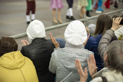 Lot of people watch show on street. people in city. spectators of performance. city festival.