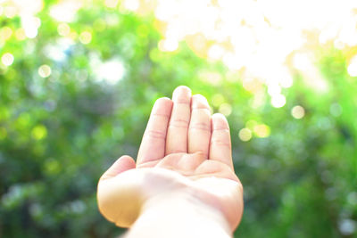 Close-up of hand against sky