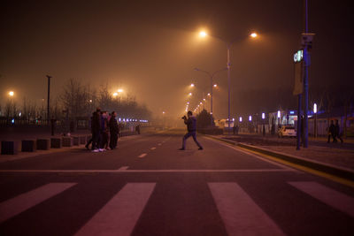 People walking on road at night