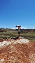 Full length of woman on field against clear sky