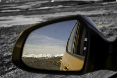 Reflection of car on side-view mirror