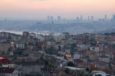 High angle view of buildings in city at sunset