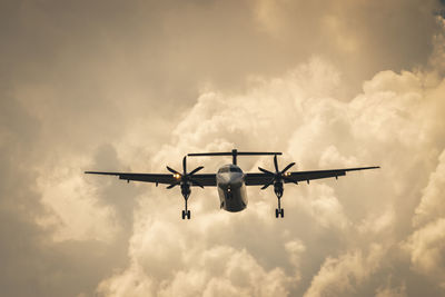 Low angle view of airplane flying against sky