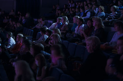 People watching serious movie in theater 