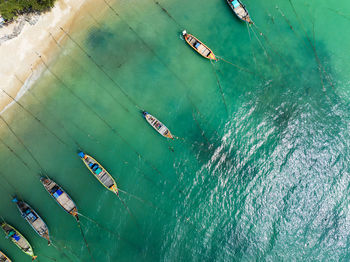 Aerial view top down longtail fishing boats at the sea in phuket thailand