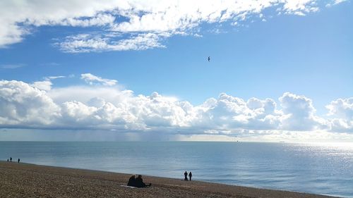 View of calm beach against blue sky