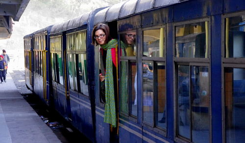 Portrait of woman standing on train