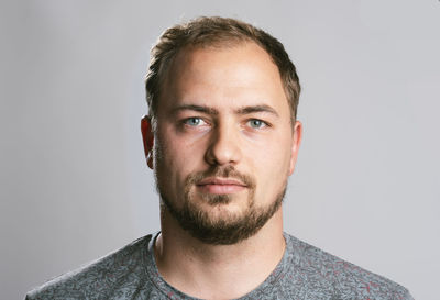 Portrait of young man against white background