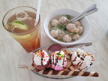 High angle view of ice cream sundae with meat ball soup and drink on table