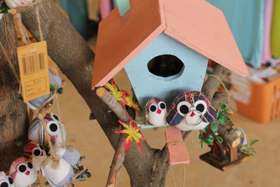 High angle view of birdhouse with bird toys for sale in store