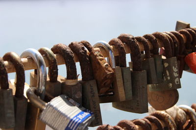 Close-up of padlocks hanging on railing