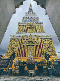 Low angle view of statues on building against sky