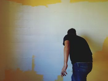 Woman standing against wall