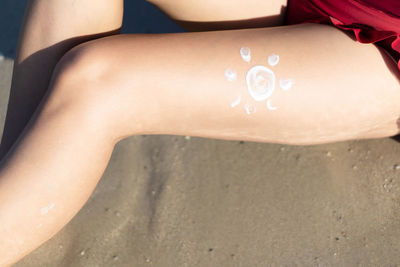 Low section of woman on beach