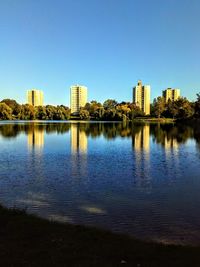 Reflection of buildings in lake against sky