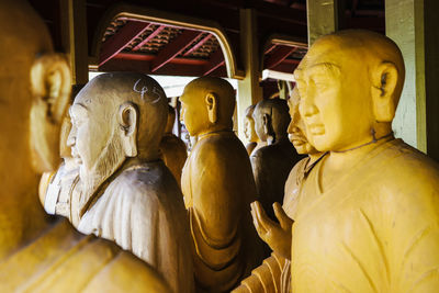 Wooden statues of buddha in building