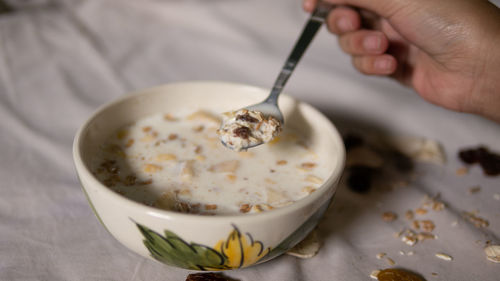 High angle view of person preparing food in bowl on table