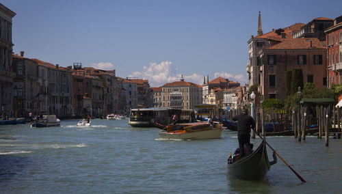 Boats in town against sky