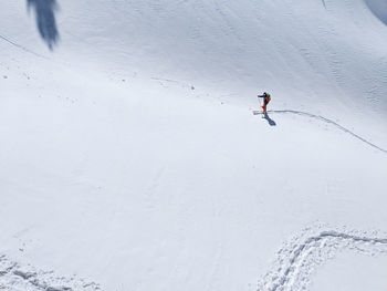 High angle view of person skiing on snow covered land