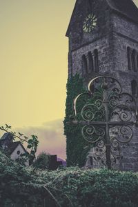 Cross on cemetery against sky