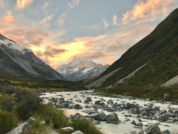 Scenic view of lake against mountains during sunset