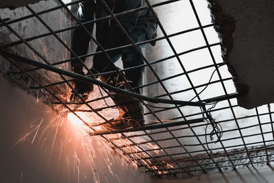 Low angle view of manual worker welding metal in factory