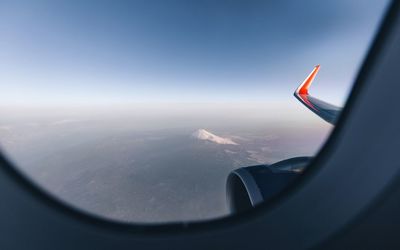 Cropped image of airplane flying over landscape