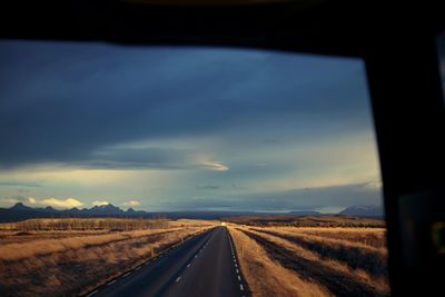 Country road passing through field