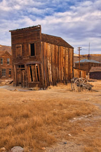 Abandoned built structure on field against sky