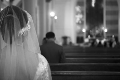 Close-up of bride sitting in church