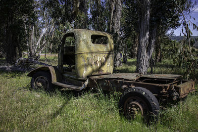 Old abandoned truck on field