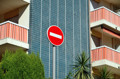 Low angle view of road sign against sky