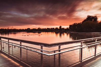 Scenic view of river against orange sky