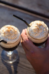 Cropped image of hand holding coffee cup