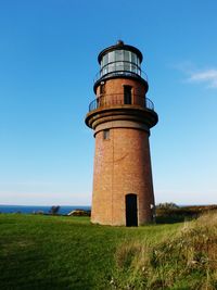 Low angle view of light house against clear blue sky